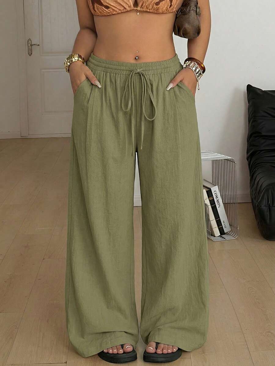 Plus size women's striped loose straight leg cropped pants with pleated detailing and side pockets