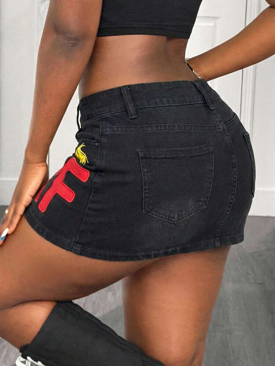 Women's black low waist bodycon mini skirt with button detail, pockets, and zipper closure
