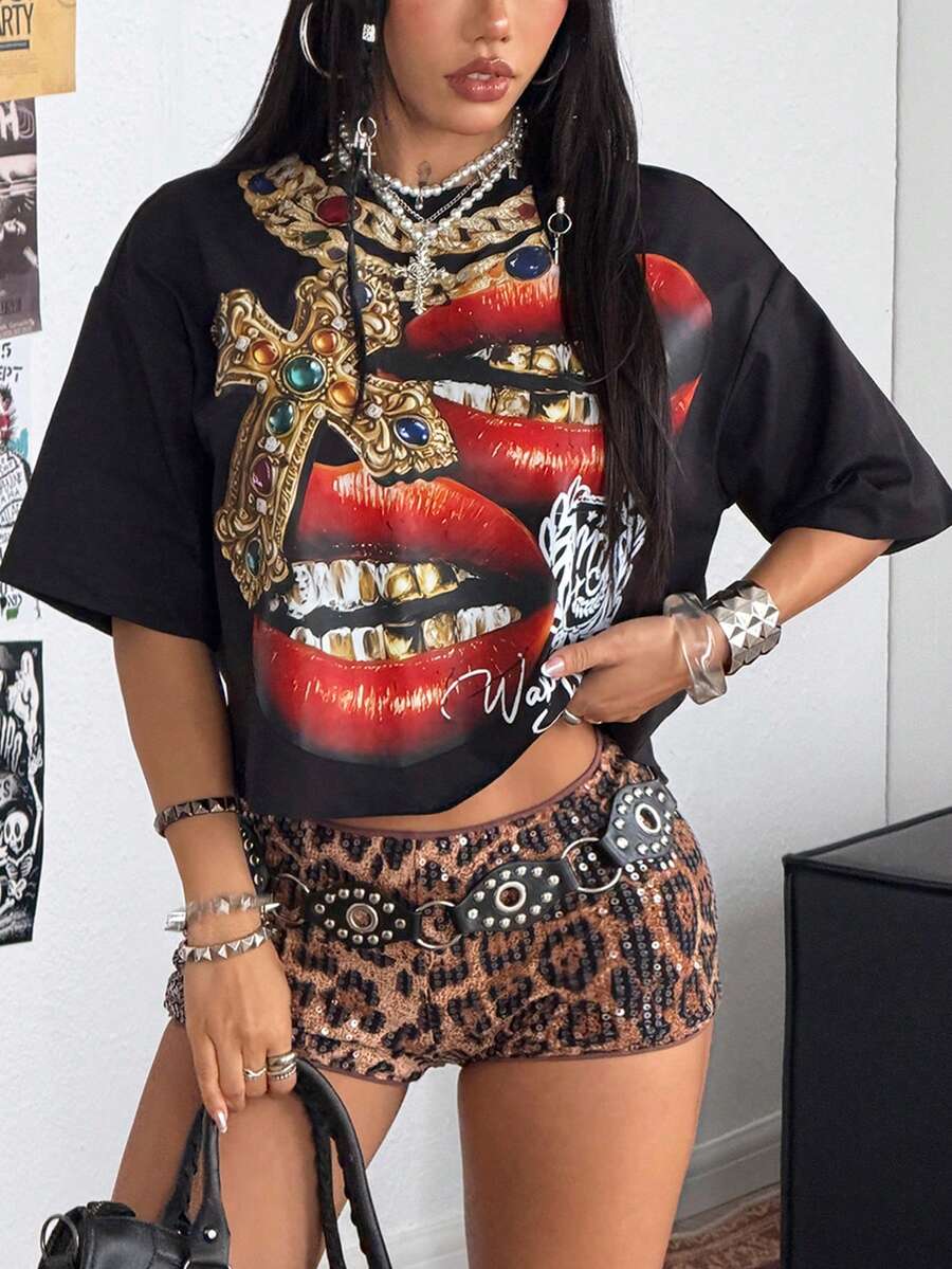 Front view of a women's black oversized crop t-shirt with pink lips graphic, round neckline, and short drop-shoulder sleeves.
