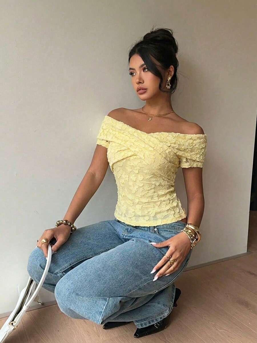 Women's off-the-shoulder slim fit short sleeve t-shirt featuring contrast lace trim and textured knitted fabric.