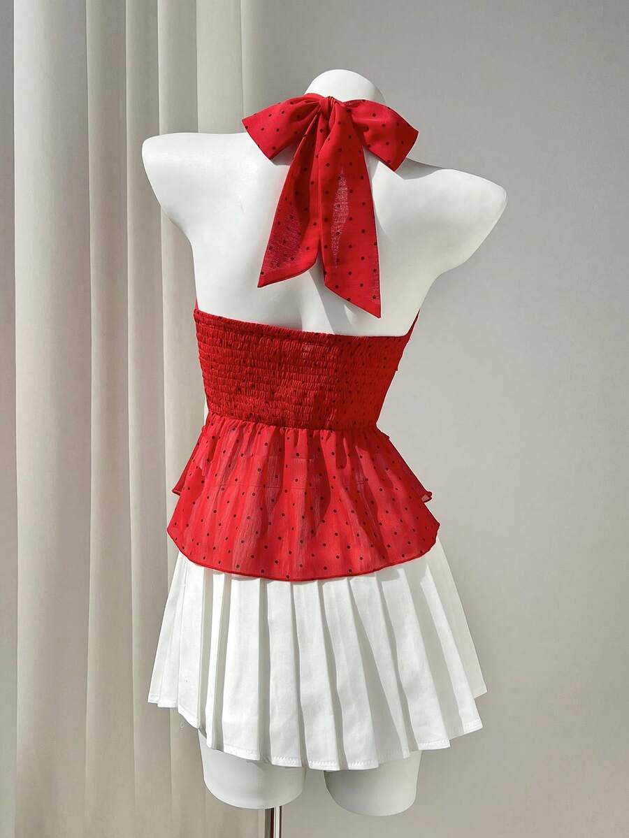 Women's white sleeveless halter neck top featuring pleated fabric, backless tie strap design, and a flared layered ruffle hem.