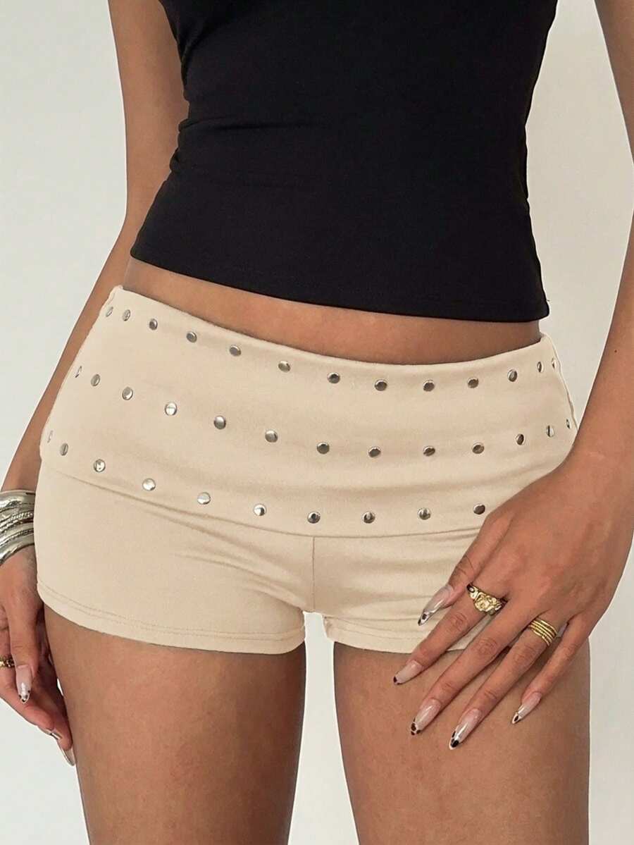 Women's ultra low waist mini shorts with rhinestone studded detailing, skinny fit, and mini length.
