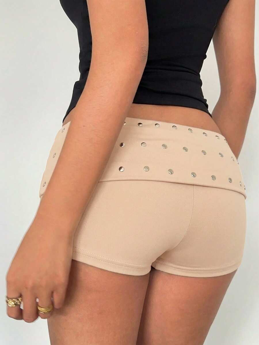 Women's studded PU ultra low waist mini shorts with zipper fly closure, skinny fit, mini length, and plain unlined design.