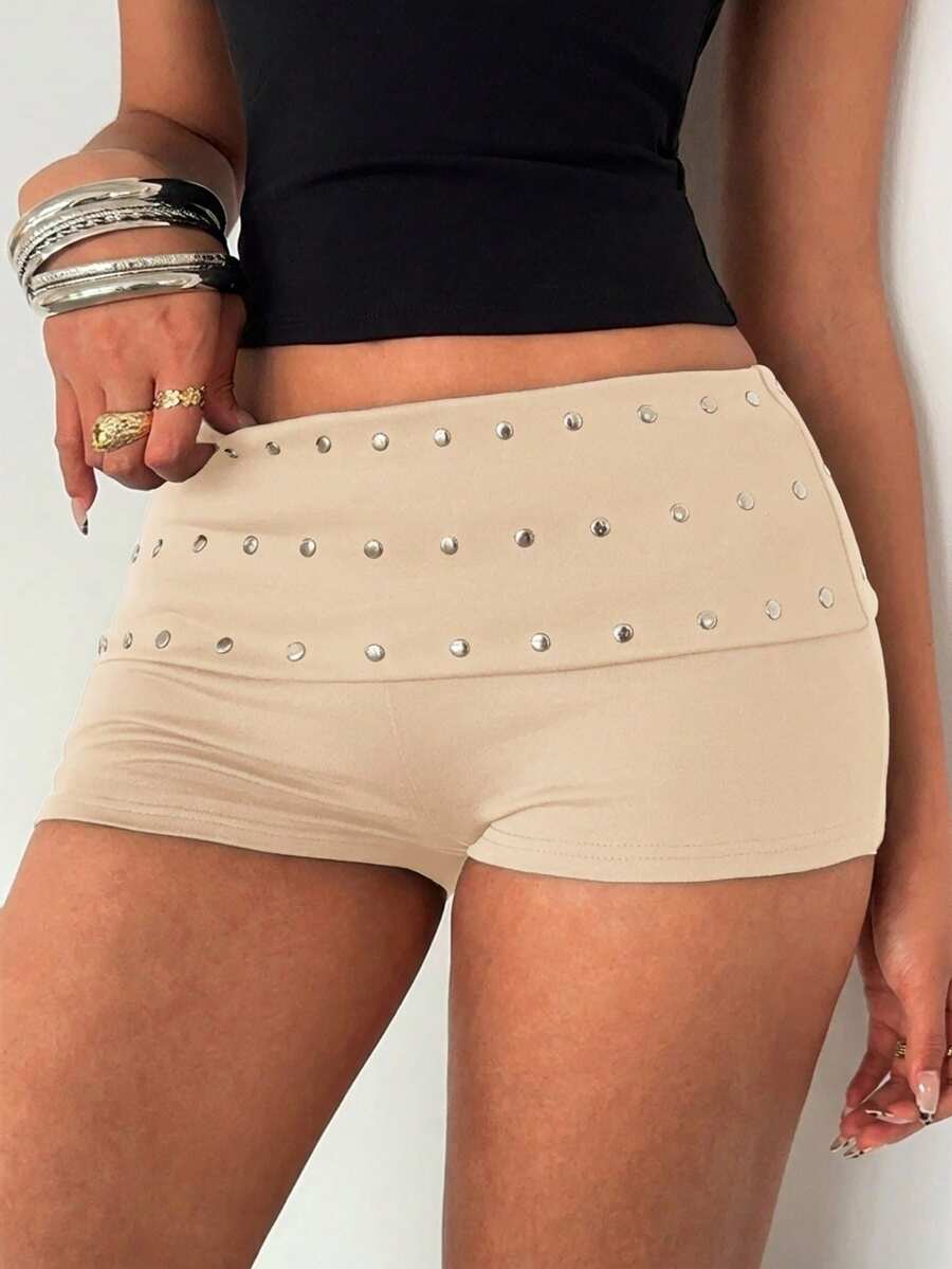 Women's studded PU ultra low waist mini shorts with zipper fly closure, skinny fit, mini length, and plain unlined design.