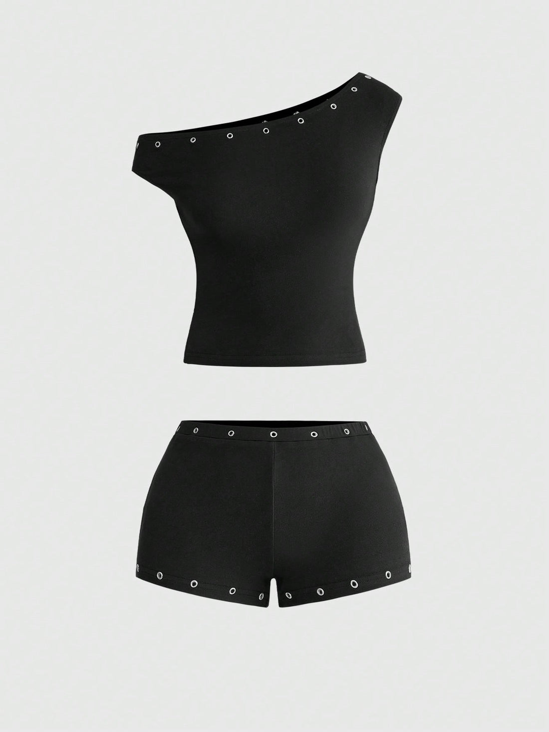 Women's two-piece outfit with an asymmetric neck studded grommet crop top and super low-rise mini shorts