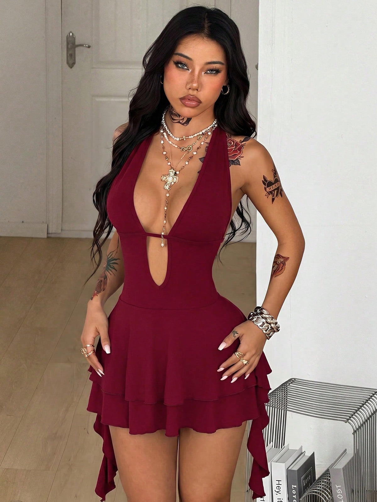 Women's sleeveless backless halter mini dress in coffee brown with a deep v-neckline, tie back detail, and a tiered A-line skirt.