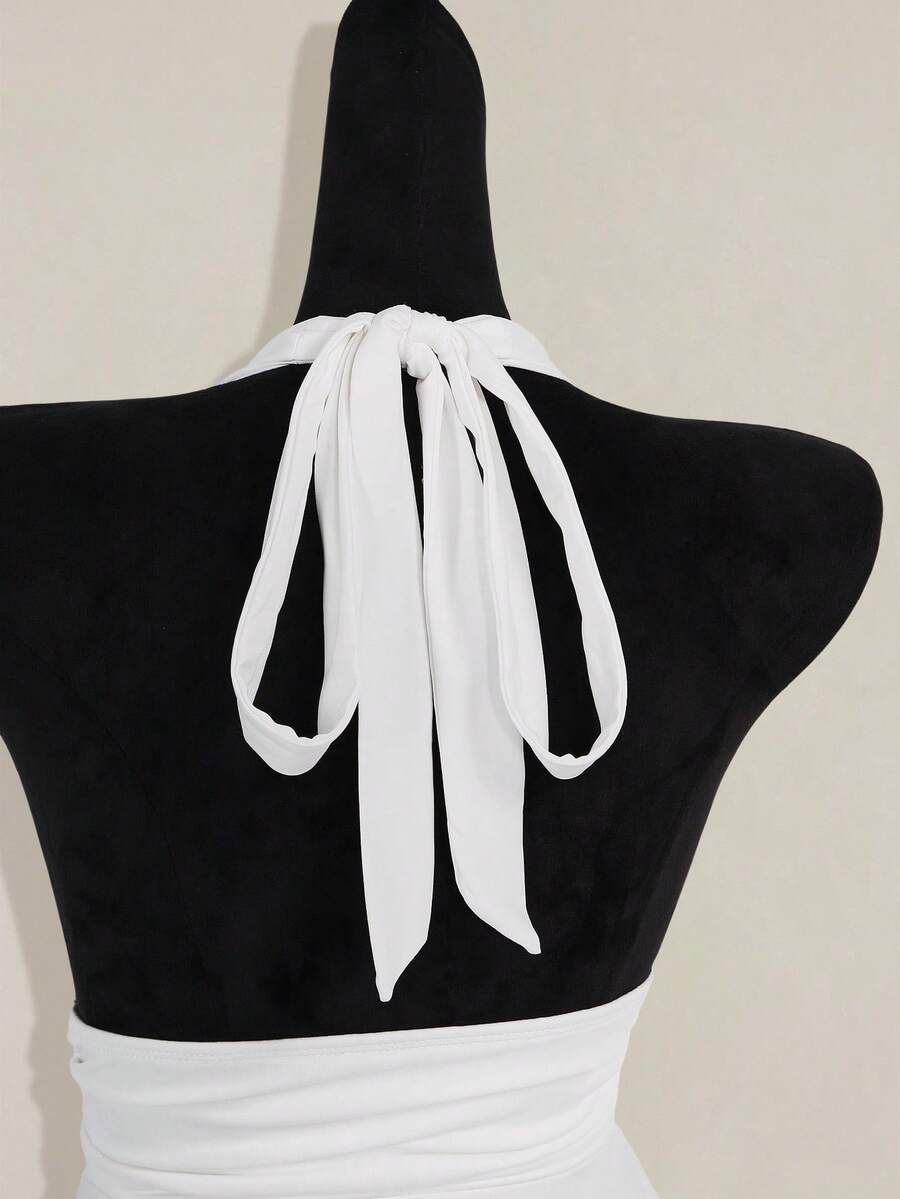 Women's backless halter babydoll tank top featuring a square neckline, slim fit silhouette, and a flared ruffle hem.