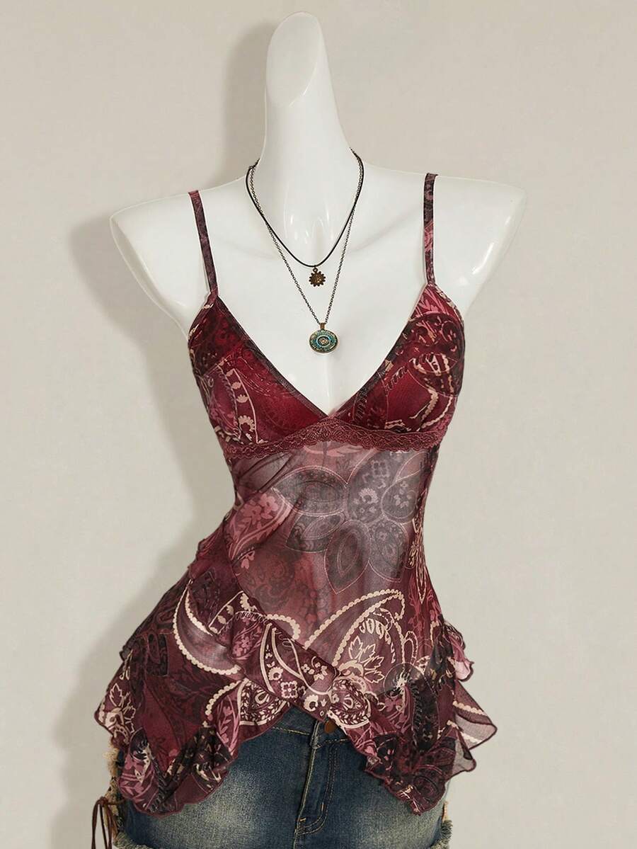 Women's graphic print camisole top featuring thin spaghetti straps, a backless cut, and an asymmetrical hem.