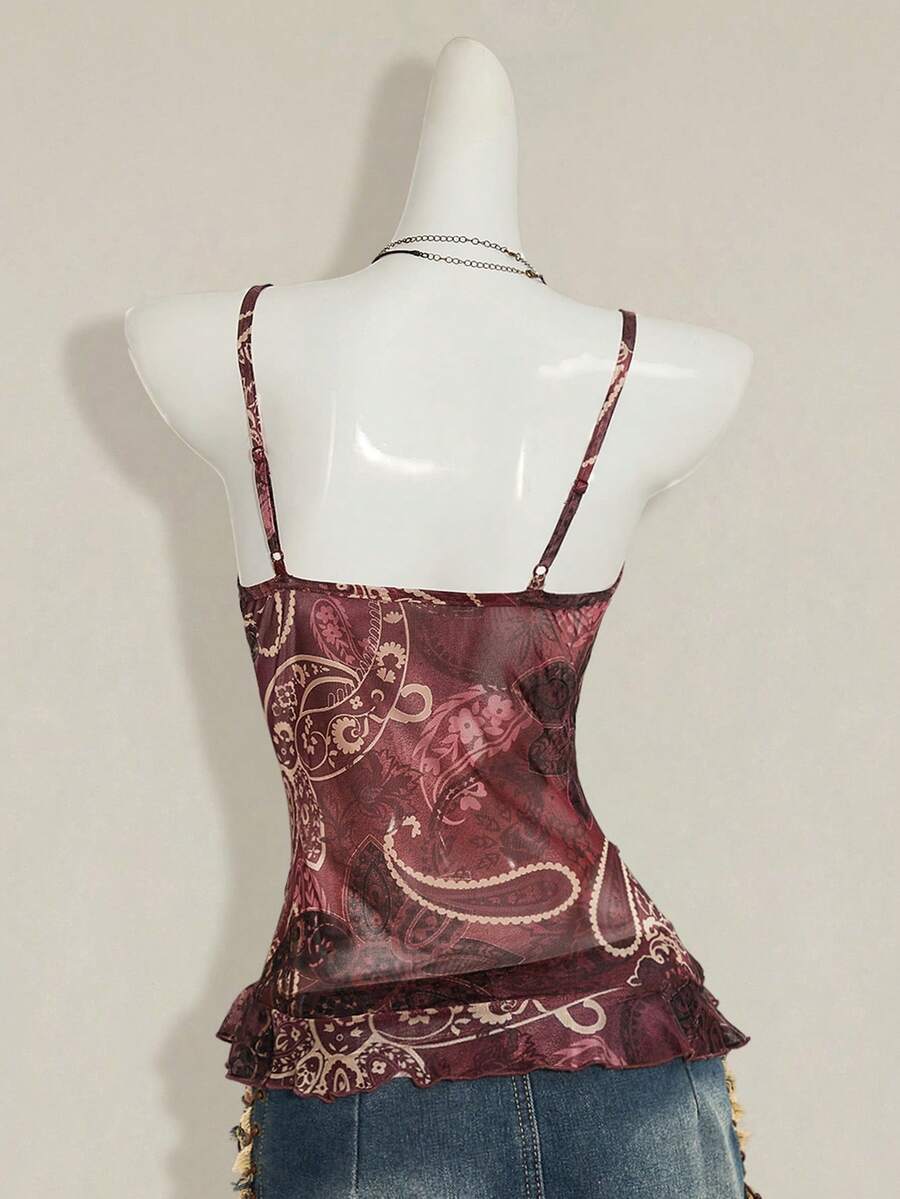 Women's graphic print camisole top featuring thin spaghetti straps, a backless cut, and an asymmetrical hem.