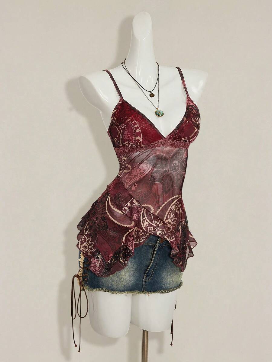 Women's graphic print camisole top featuring thin spaghetti straps, a backless cut, and an asymmetrical hem.