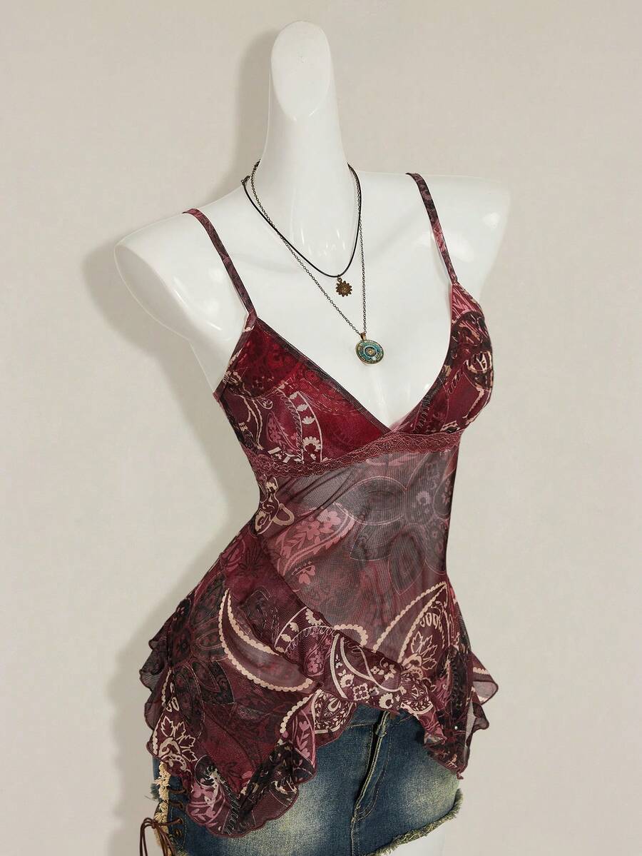 Women's graphic print camisole top featuring thin spaghetti straps, a backless cut, and an asymmetrical hem.