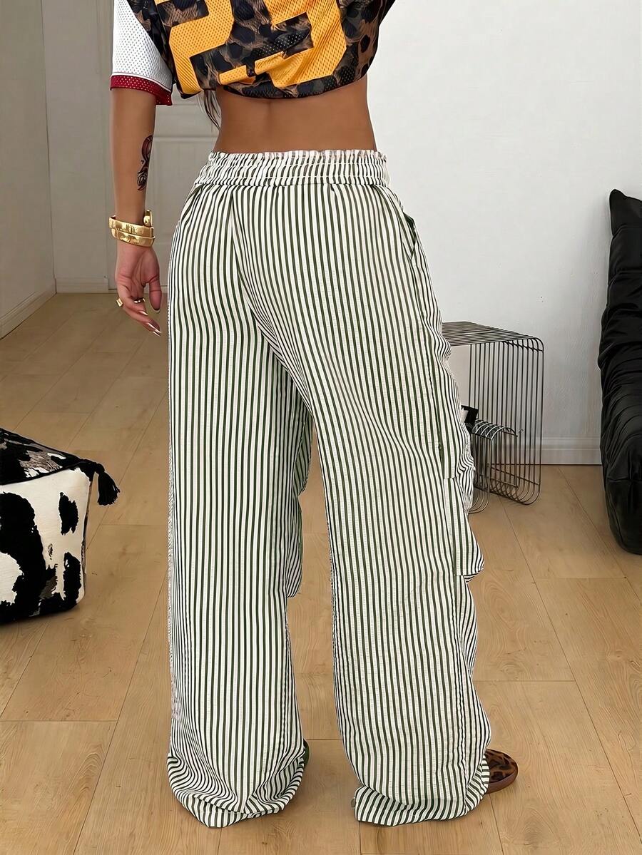 Women's black and white striped wide leg pants featuring an elastic drawstring waistband, side pockets, and a loose straight leg fit.