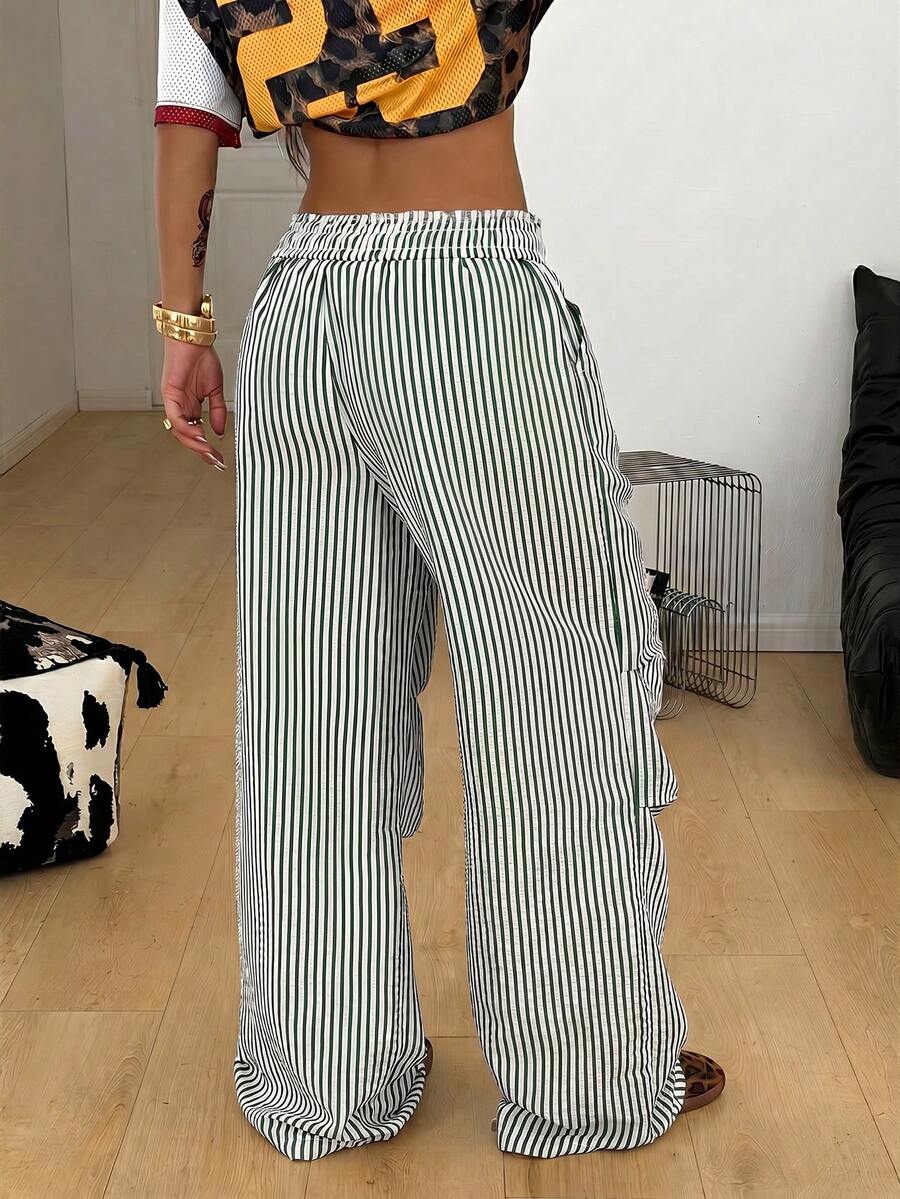 Women's black and white striped wide leg pants featuring an elastic drawstring waistband, side pockets, and a loose straight leg fit.