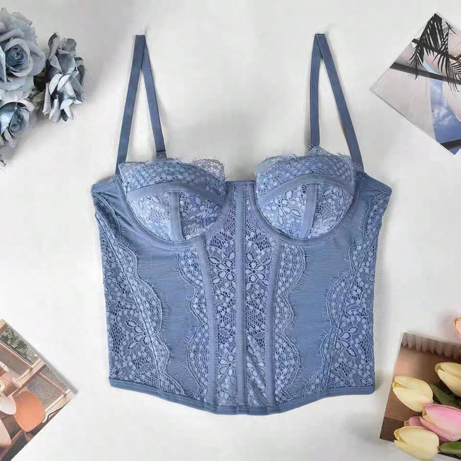 Women's lace bustier corset cami top with spaghetti straps, arm sleeves, asymmetrical contrast lace detail, and buckle accent