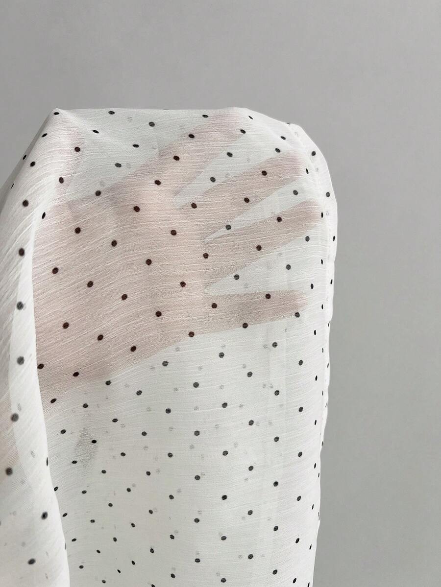 Women's white sleeveless halter neck top featuring pleated fabric, backless tie strap design, and a flared layered ruffle hem.