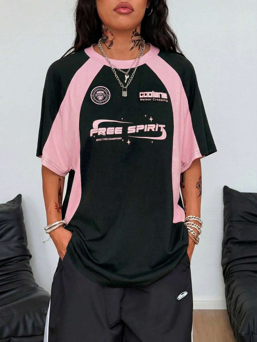 Unisex plus size oversized jersey t-shirt in brown featuring a round neck, short raglan sleeves with contrast binding, and a front letter graphic print.