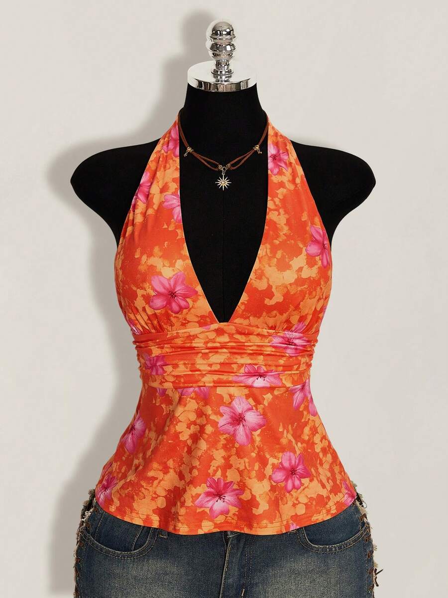 White women's deep V-neck halter tank top with ruched waist, backless design, rib-knit texture, and ruffle hem