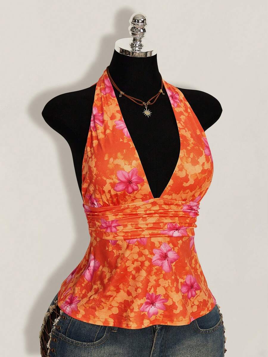 White women's deep V-neck halter tank top with ruched waist, backless design, rib-knit texture, and ruffle hem