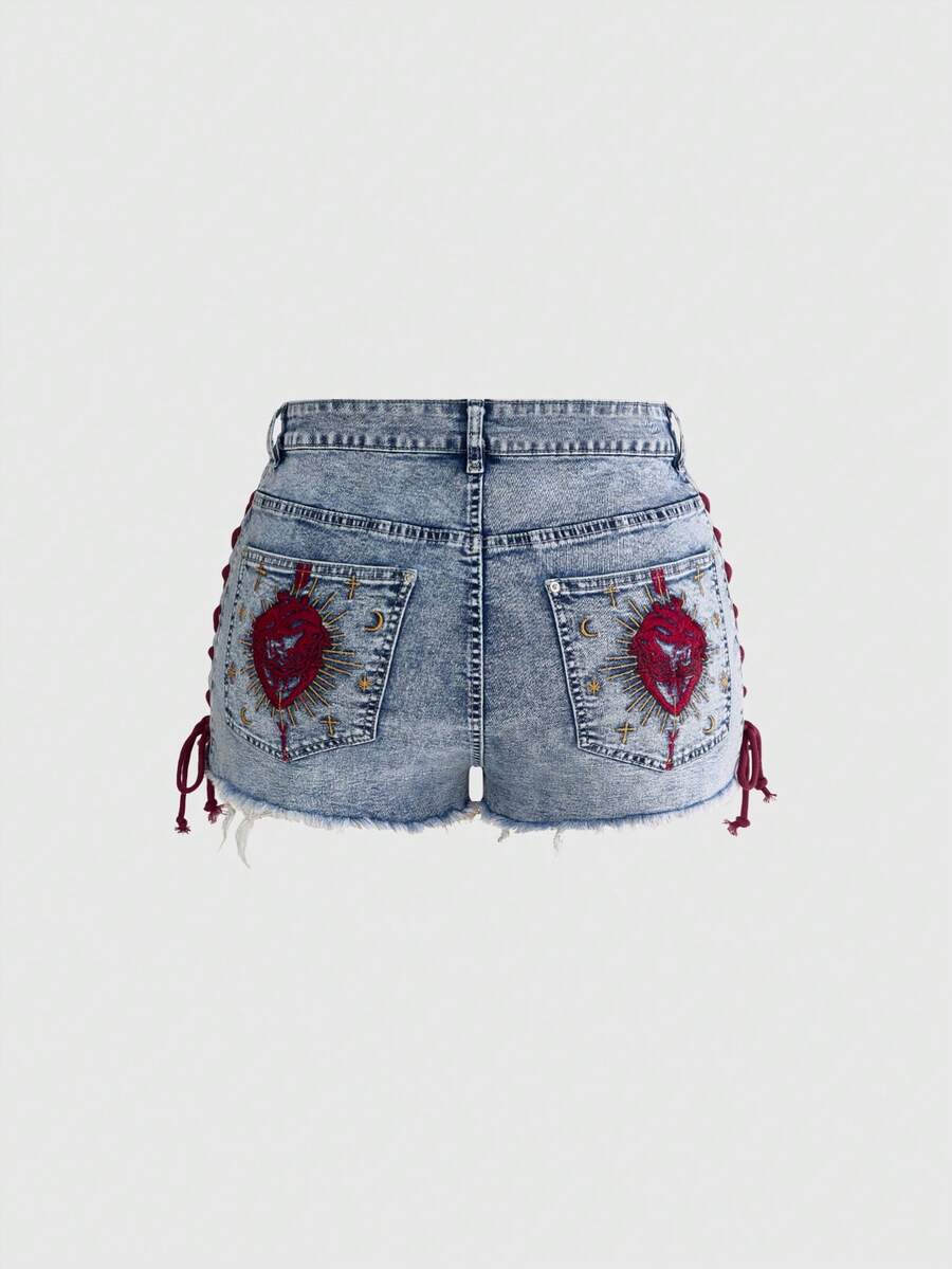 Plus size black gothic mini shorts with heart embroidery, graphic pocket pattern, lace-up detail, raw hem, and zipper fly