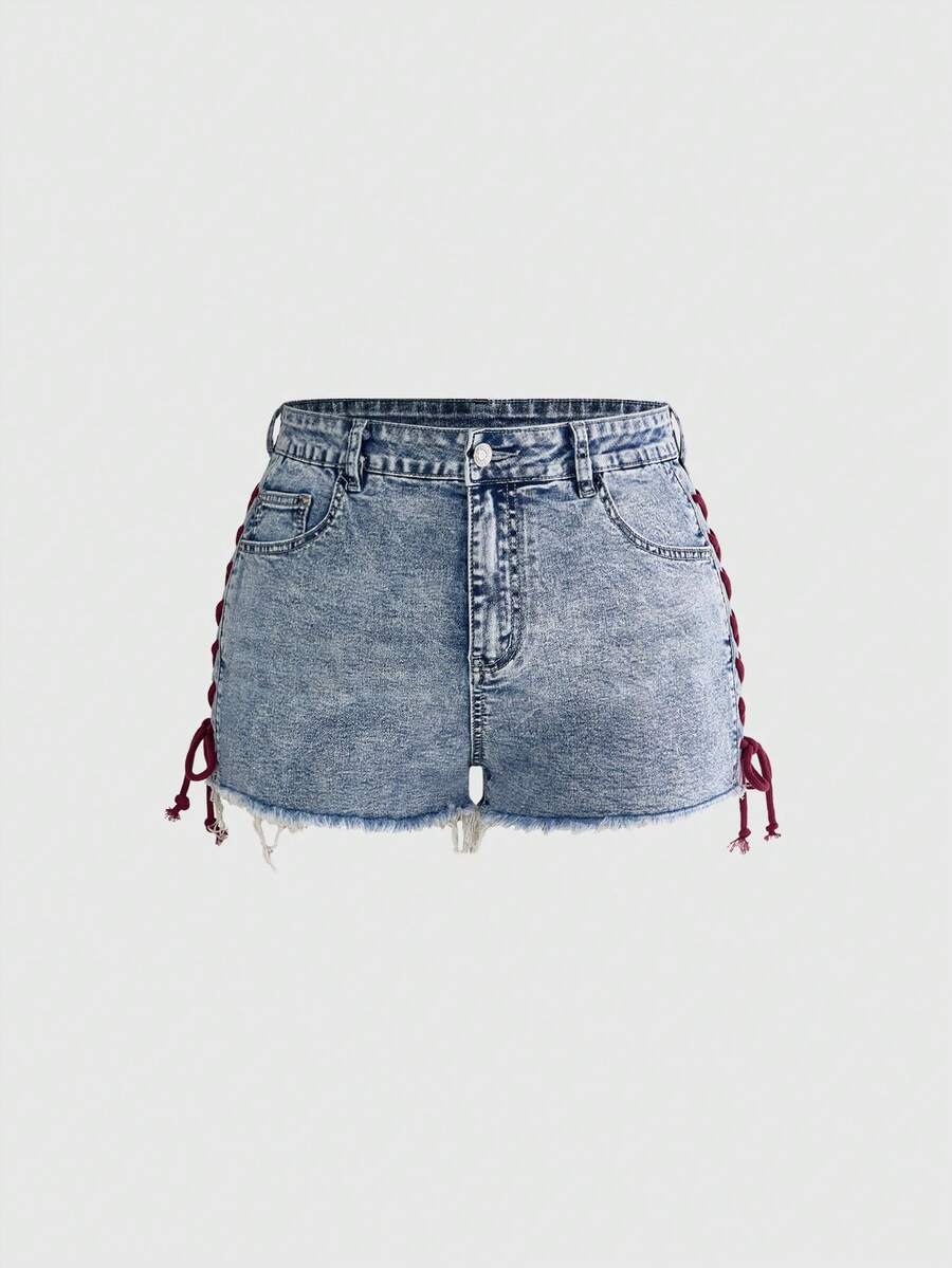Plus size black gothic mini shorts with heart embroidery, graphic pocket pattern, lace-up detail, raw hem, and zipper fly
