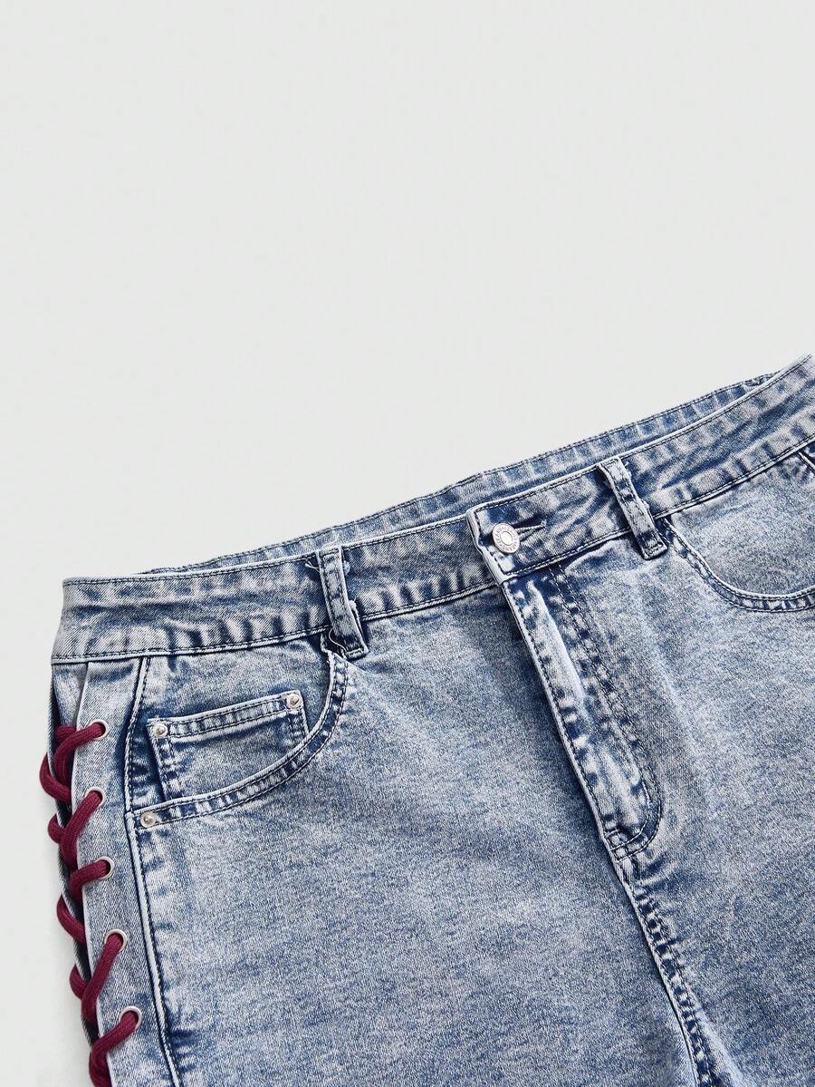 Plus size black gothic mini shorts with heart embroidery, graphic pocket pattern, lace-up detail, raw hem, and zipper fly