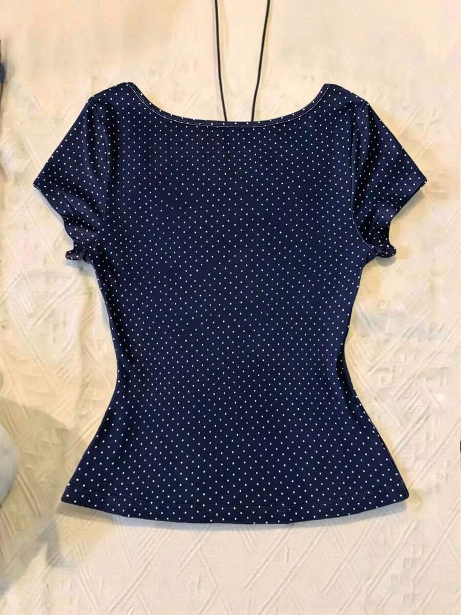 Women's polka dot short sleeve raglan t-shirt with a twist front detail and contrast collar.