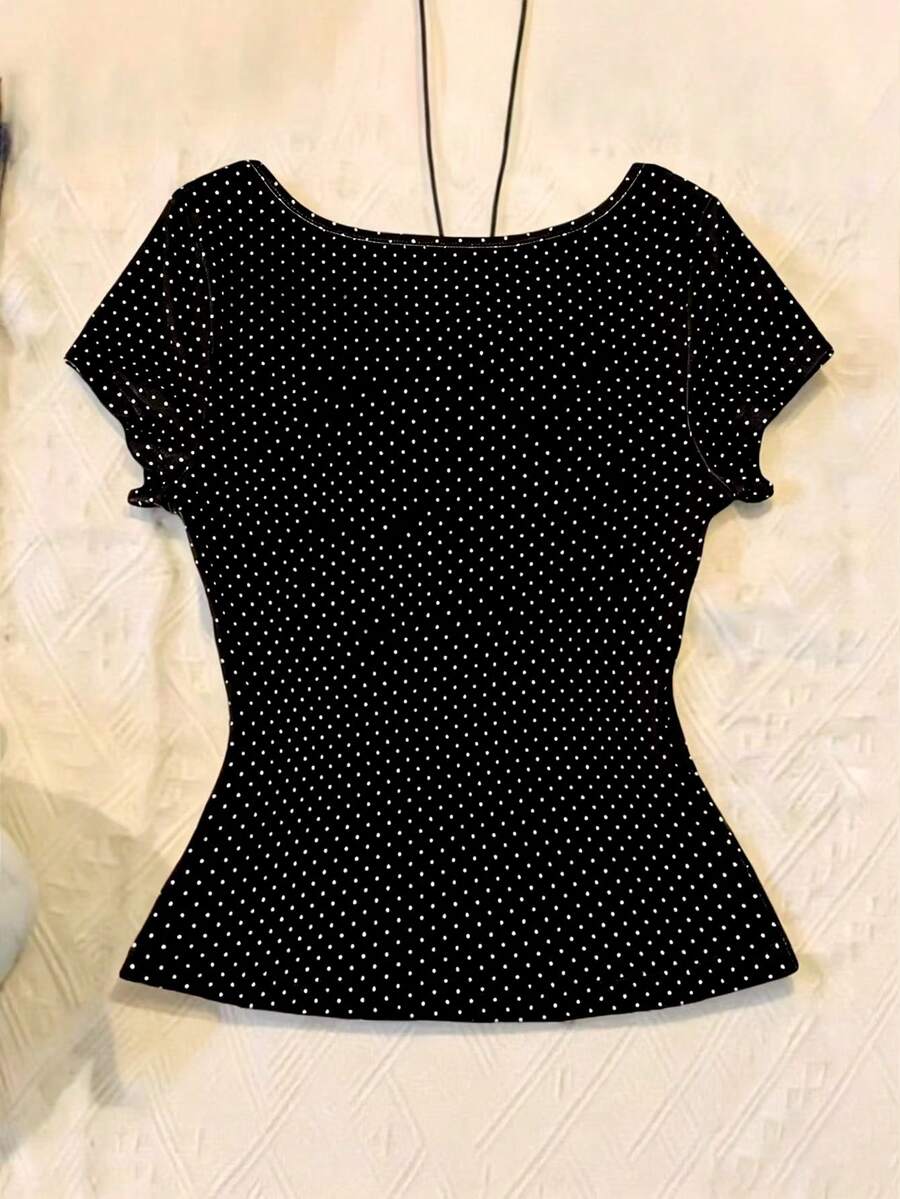 Women's polka dot short sleeve raglan t-shirt with a twist front detail and contrast collar.