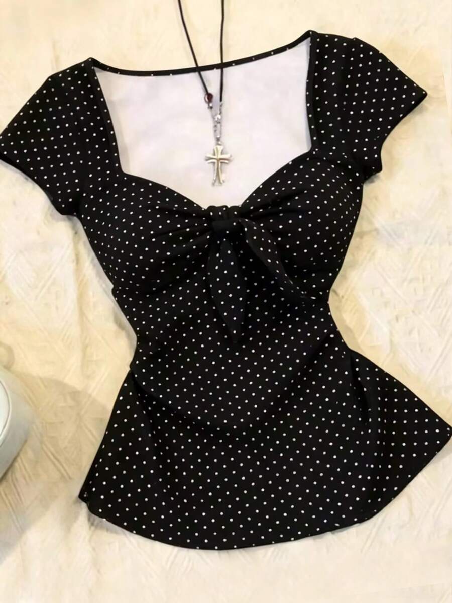 Women's polka dot short sleeve raglan t-shirt with a twist front detail and contrast collar.