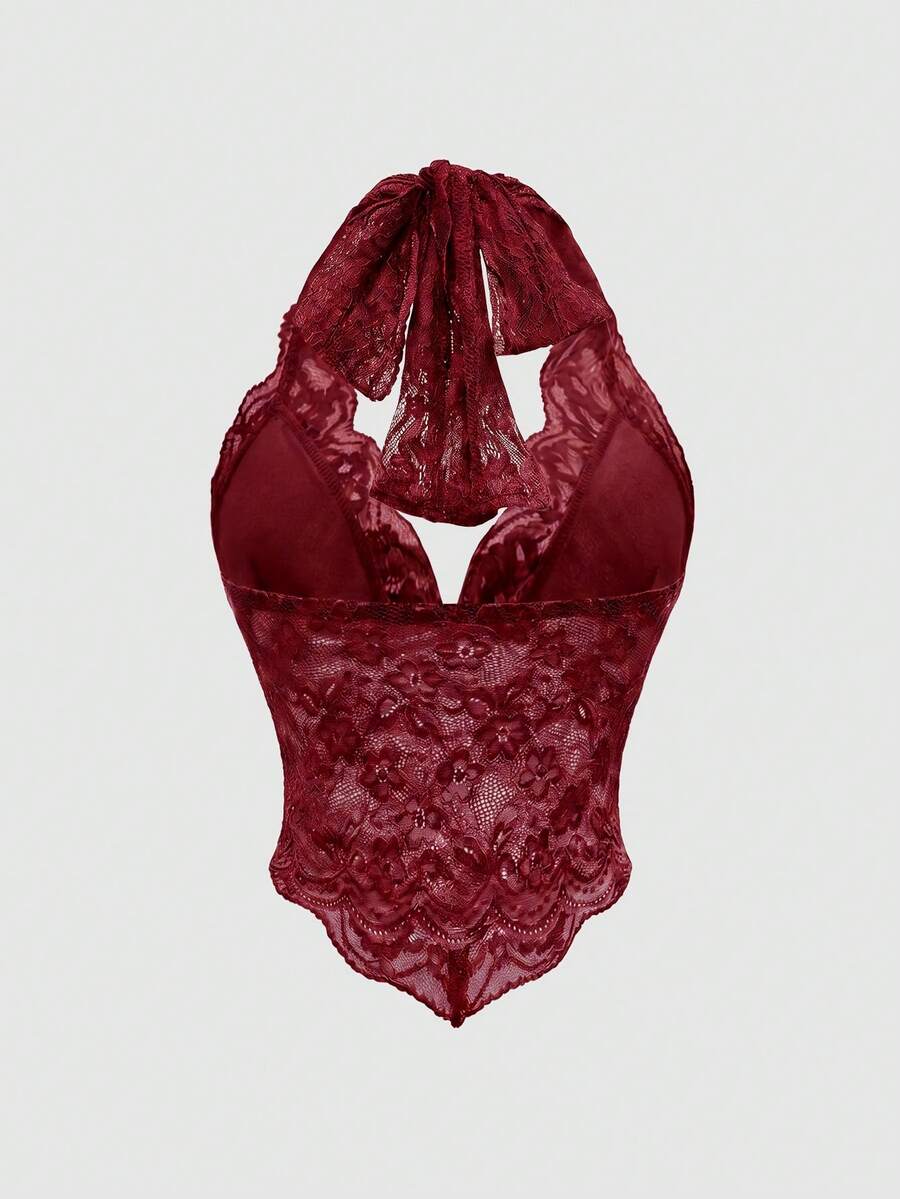 Women's lace halter neck crop top with backless tie closure, scallop trim, and asymmetrical hem.