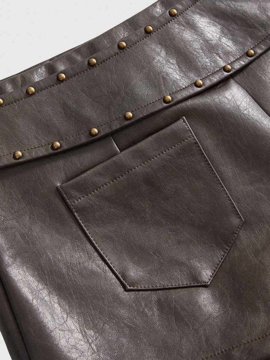 Brown ultra low waist PU bodycon mini shorts for women featuring studded rivet embellishments and a front zipper fly.