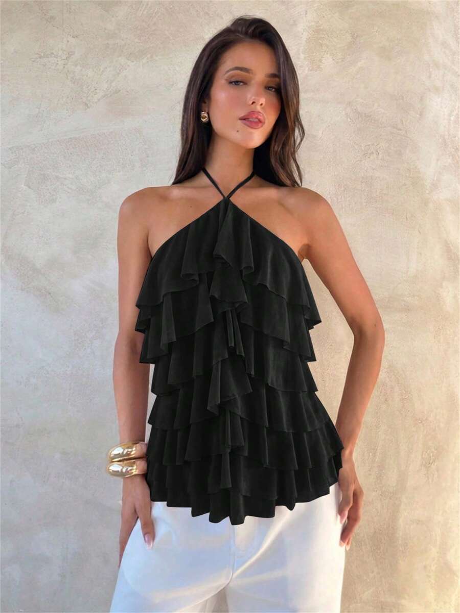Women's sleeveless halter neck top featuring tiered ruffle layers, a backless cut, and an asymmetrical hem.