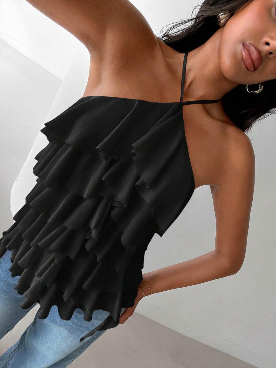 Women's sleeveless halter neck top featuring tiered ruffle layers, a backless cut, and an asymmetrical hem.