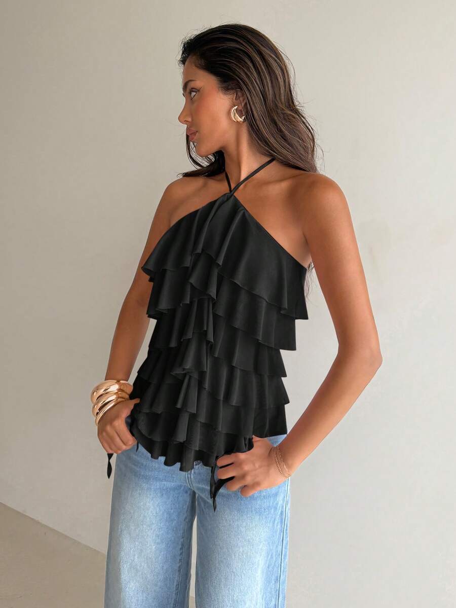 Women's sleeveless halter neck top featuring tiered ruffle layers, a backless cut, and an asymmetrical hem.