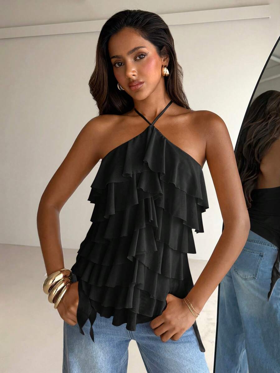 Women's sleeveless halter neck top featuring tiered ruffle layers, a backless cut, and an asymmetrical hem.