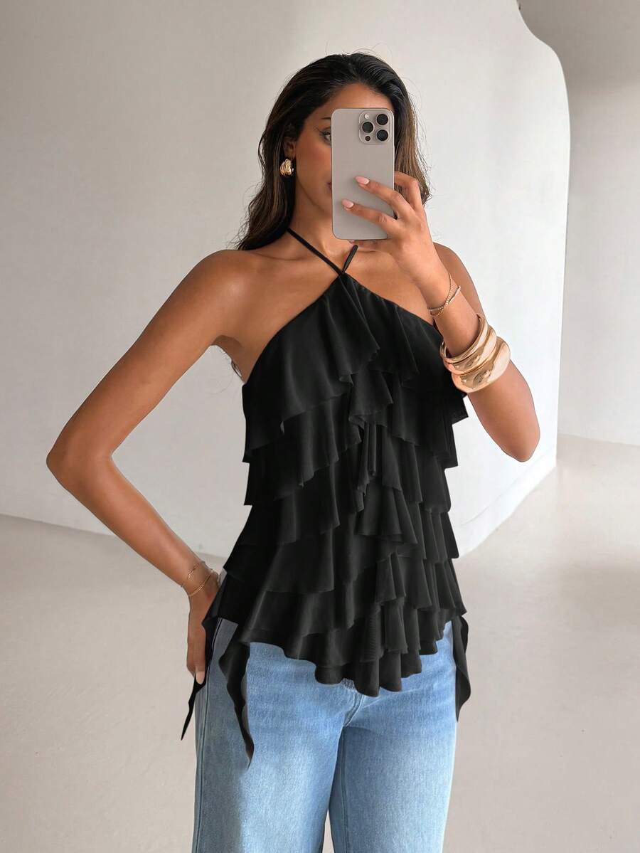 Women's sleeveless halter neck top featuring tiered ruffle layers, a backless cut, and an asymmetrical hem.