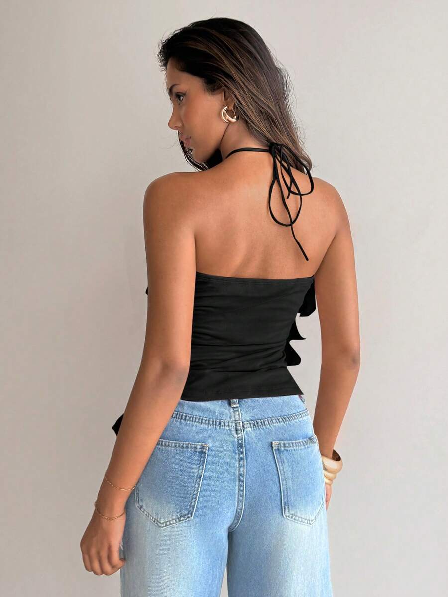 Women's sleeveless halter neck top featuring tiered ruffle layers, a backless cut, and an asymmetrical hem.