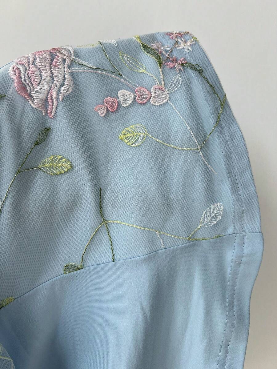 Women's pink short sleeve slim fit dress featuring a plant pattern, scoop neck, ruched appliques, and button front detail.