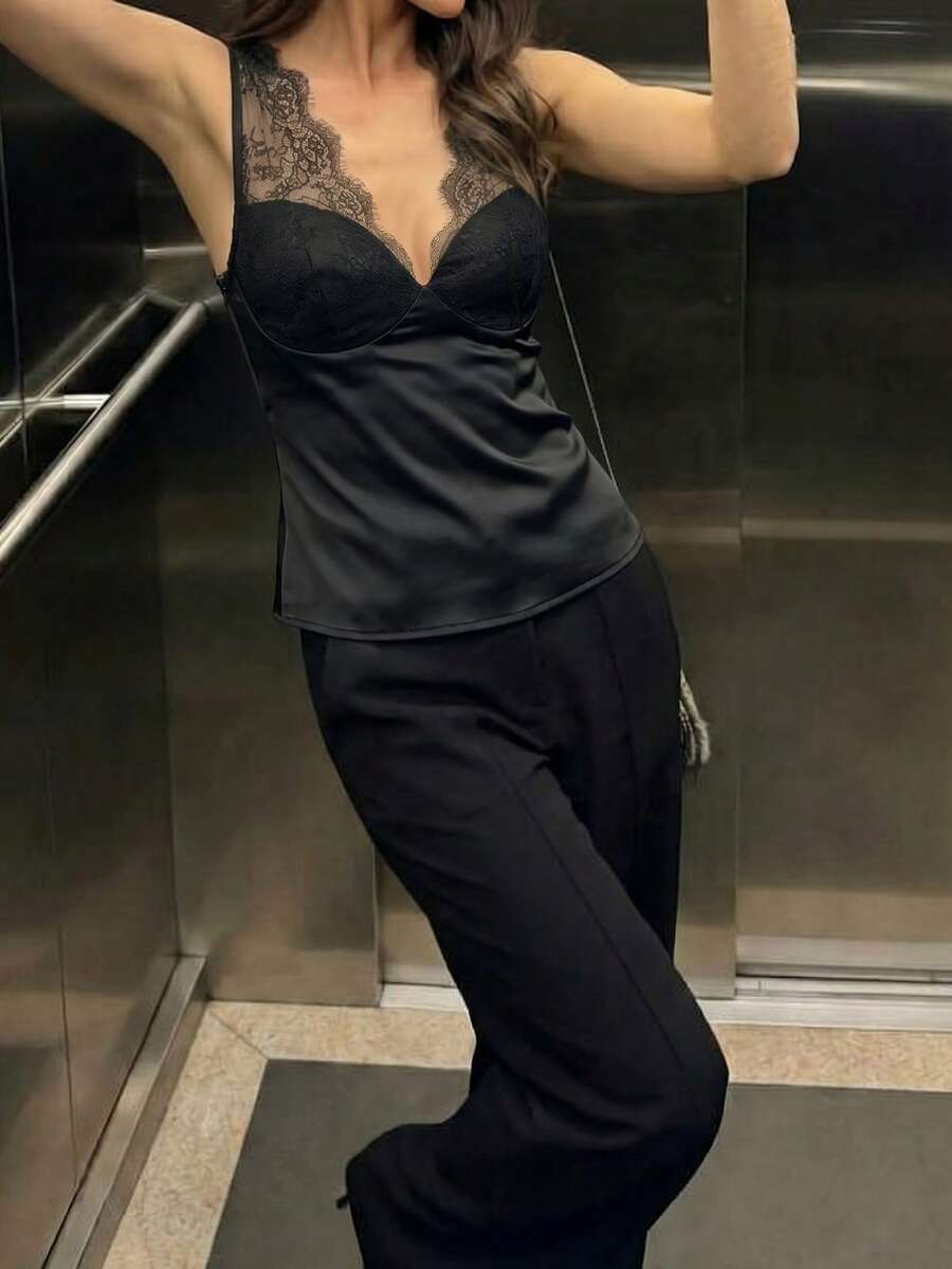 Women's black sleeveless camisole top with contrast lace trim along a deep V-neckline and wide shoulder straps.