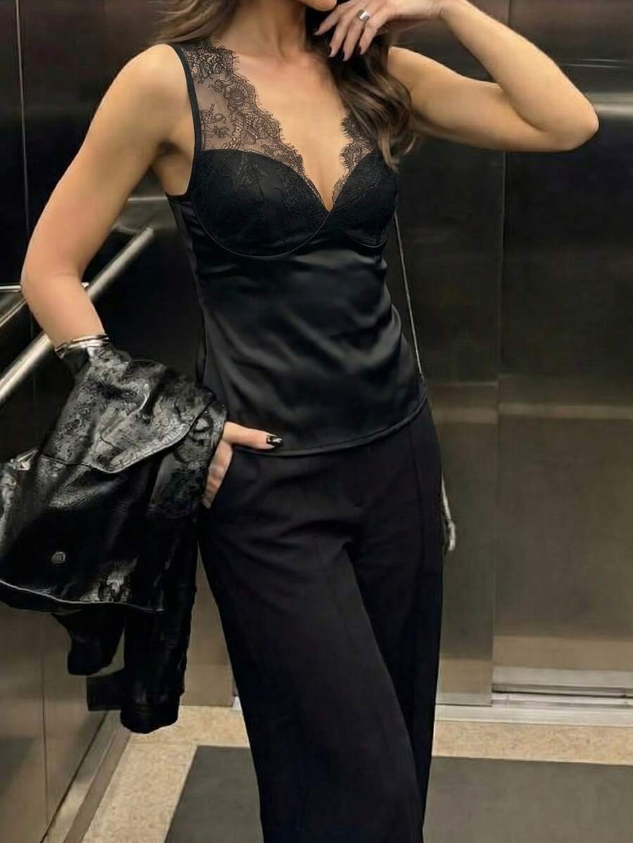 Women's black sleeveless camisole top with contrast lace trim along a deep V-neckline and wide shoulder straps.