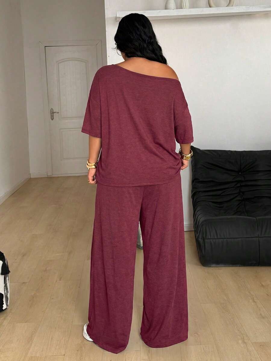 Women's casual two-piece outfit featuring a loose short-sleeve asymmetrical neck t-shirt and matching long wide leg pants with pockets.