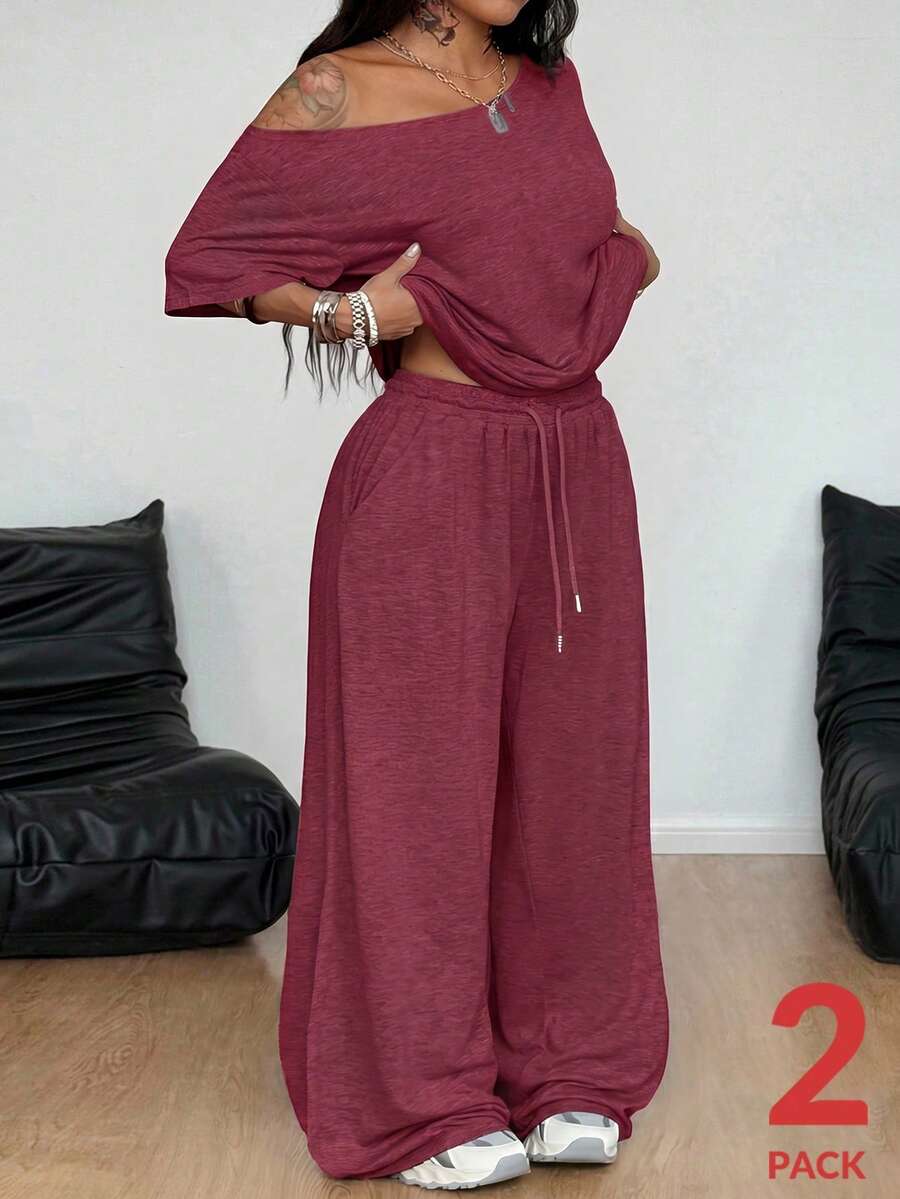 Women's casual two-piece outfit featuring a loose short-sleeve asymmetrical neck t-shirt and matching long wide leg pants with pockets.