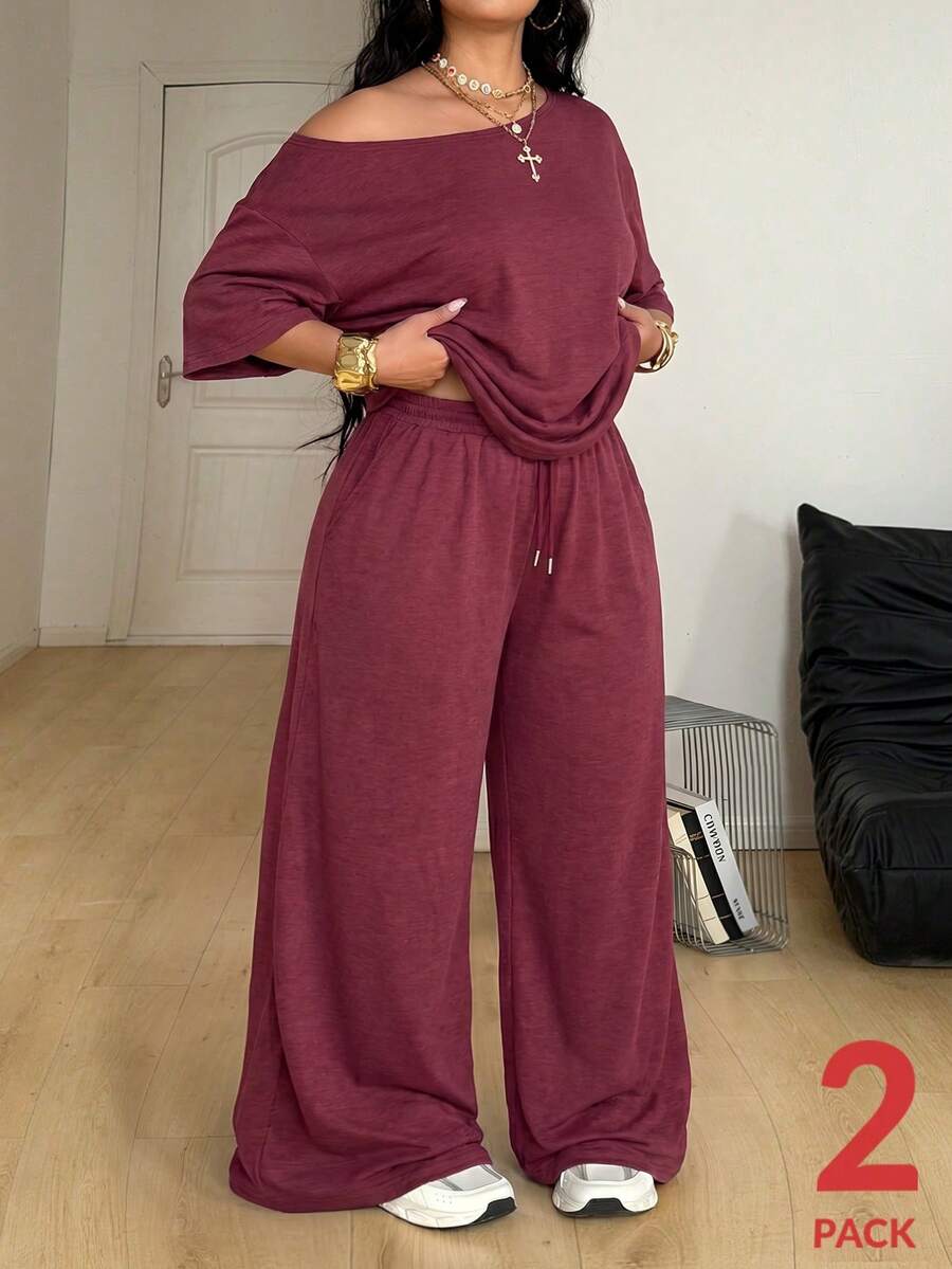 Women's casual two-piece outfit featuring a loose short-sleeve asymmetrical neck t-shirt and matching long wide leg pants with pockets.