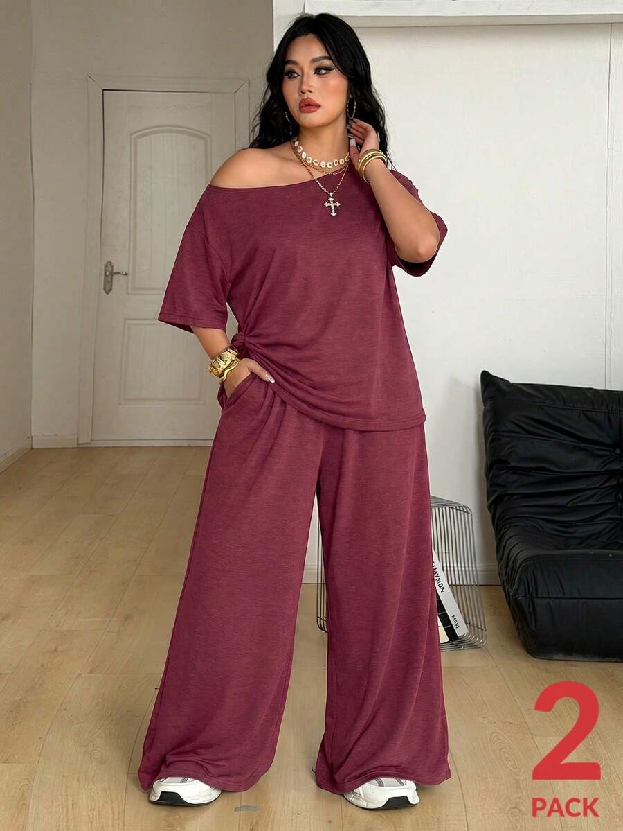 Women's casual two-piece outfit featuring a loose short-sleeve asymmetrical neck t-shirt and matching long wide leg pants with pockets.