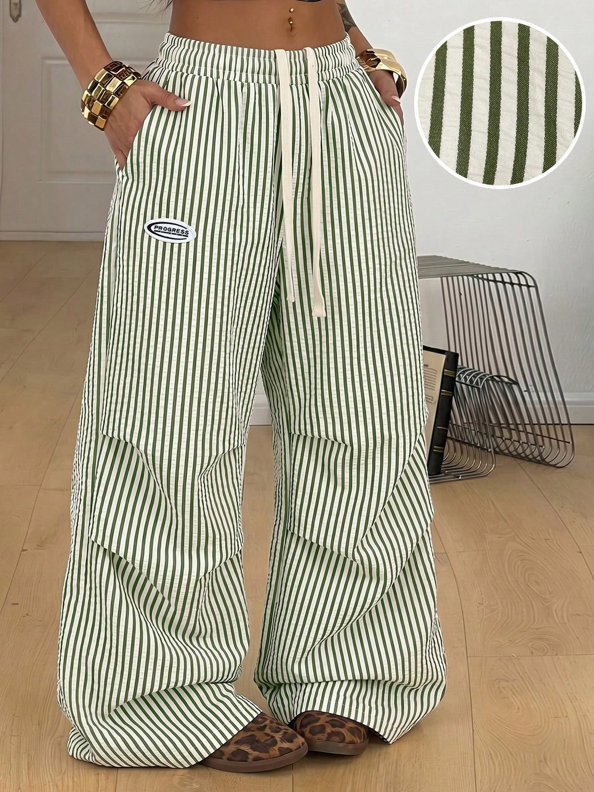 Women's black and white striped wide leg pants featuring an elastic drawstring waistband, side pockets, and a loose straight leg fit.