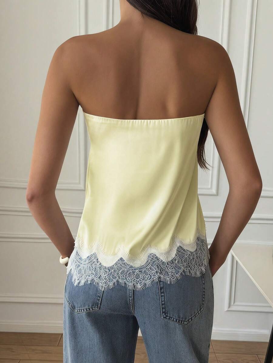 Strapless black and white bandeau top featuring a contrast lace patchwork flared hem and plant pattern.