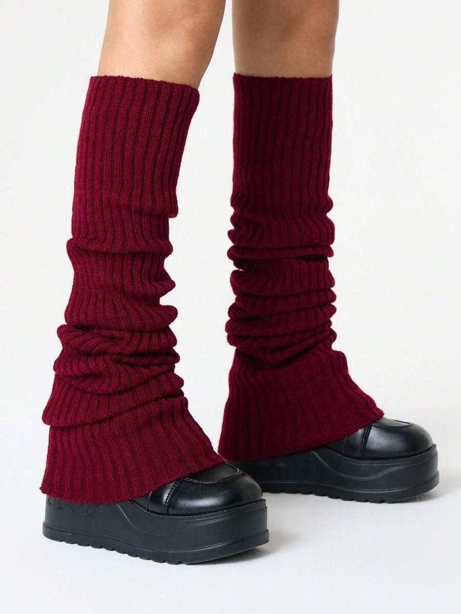 Pair of women's extra long knitted leg warmers featuring a gothic grunge design with subtle ruffle detailing.