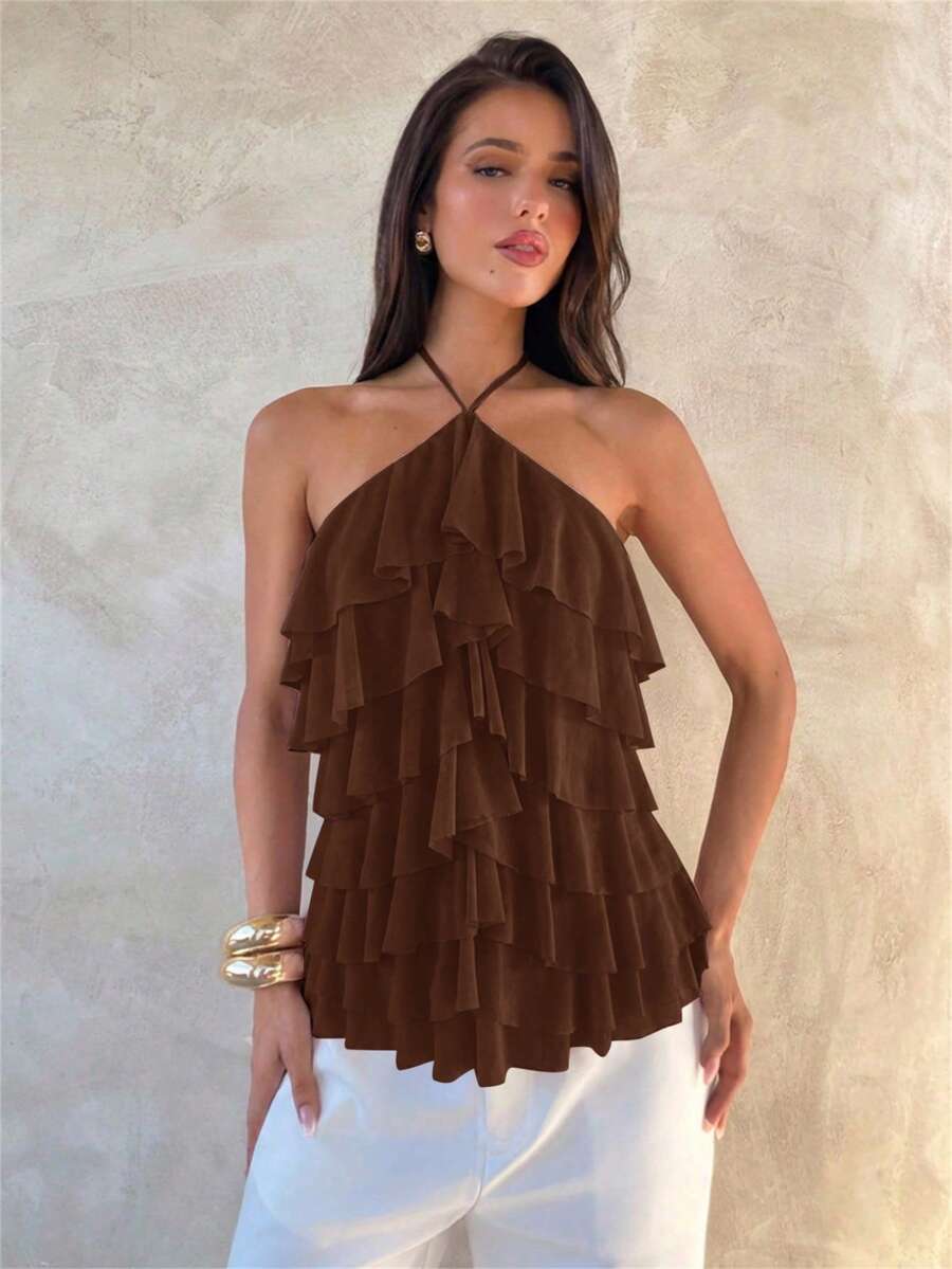 Women's sleeveless halter neck top featuring tiered ruffle layers, a backless cut, and an asymmetrical hem.