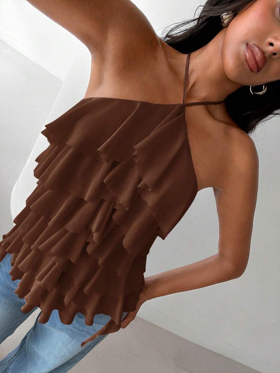 Women's sleeveless halter neck top featuring tiered ruffle layers, a backless cut, and an asymmetrical hem.