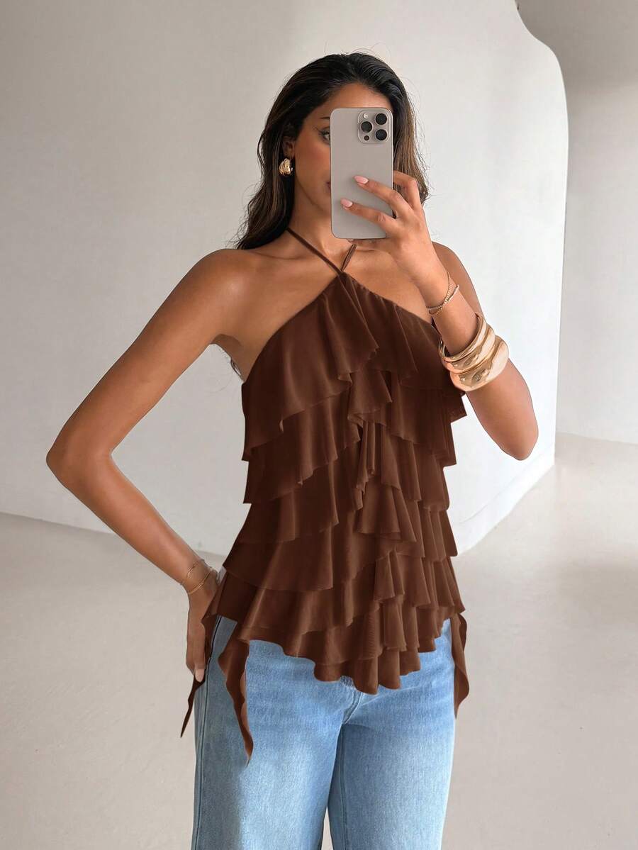 Women's sleeveless halter neck top featuring tiered ruffle layers, a backless cut, and an asymmetrical hem.