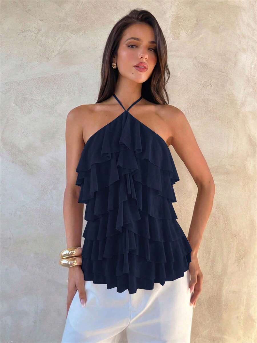 Women's sleeveless halter neck top featuring tiered ruffle layers, a backless cut, and an asymmetrical hem.
